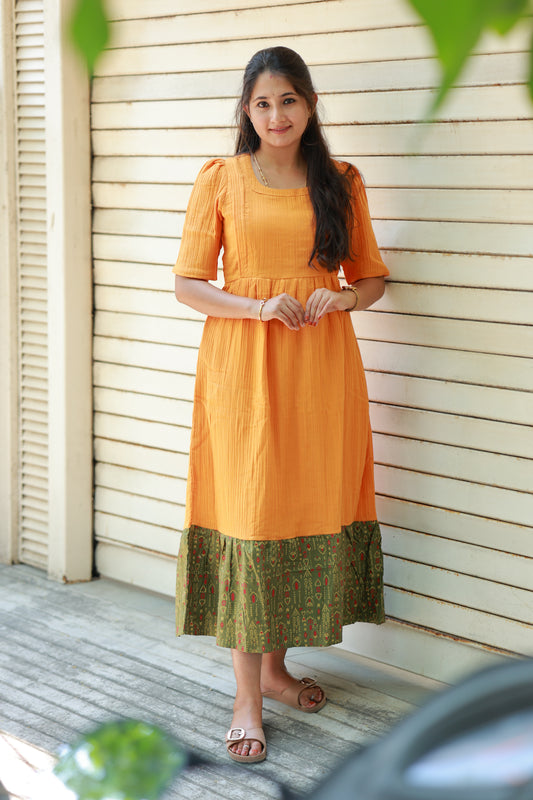 orange muslin feeding maxi dress with printed border hem, breathable summer friendly fabric, maternity wear with elegant flowy fit, plus size muslin maxi.