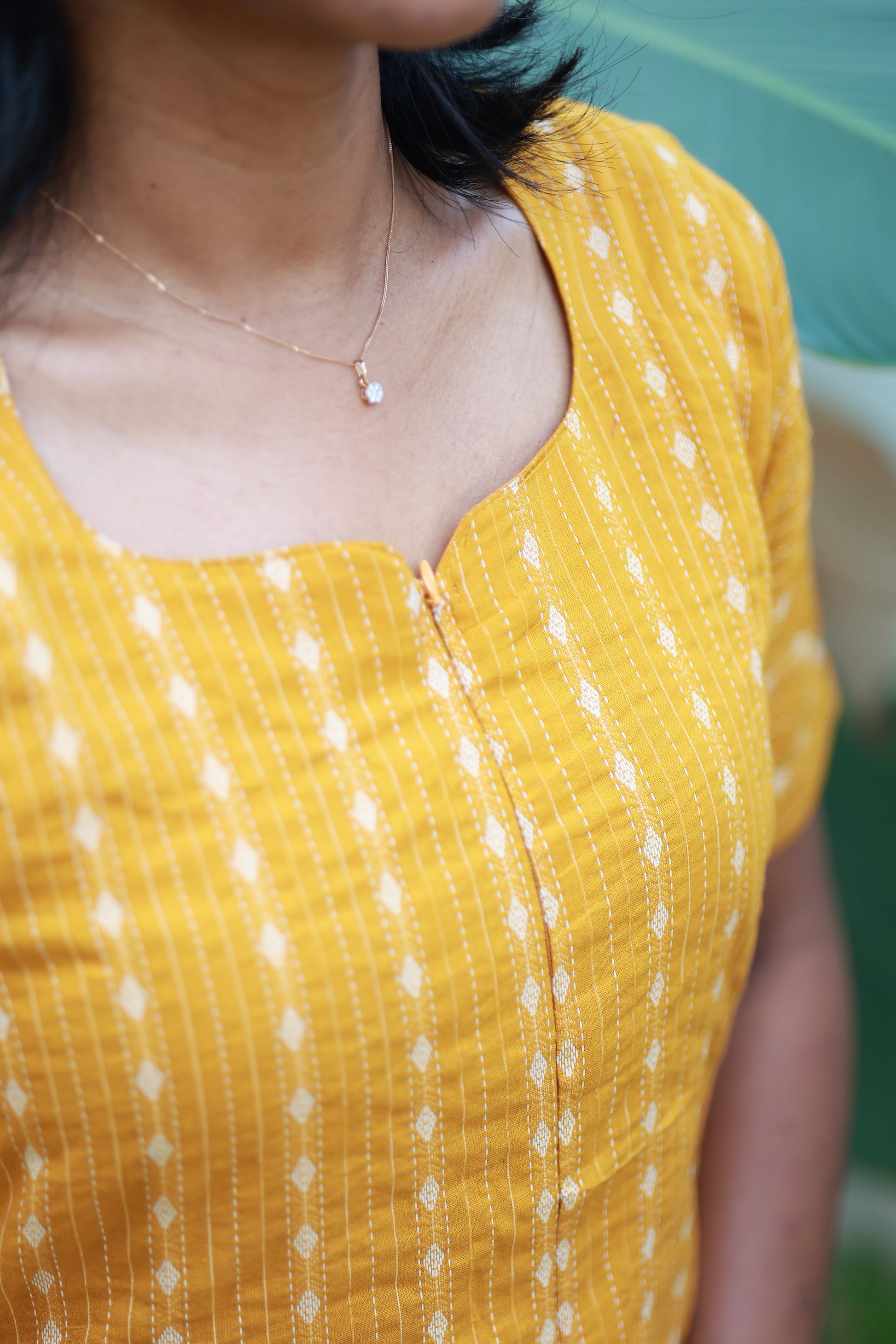 Maternity tops - 2 piece set [ kurta and pant ] - Yellow color. close-up showing soft breathable  ikkat fabric and feeding option. Easy front zip access for nursing mothers