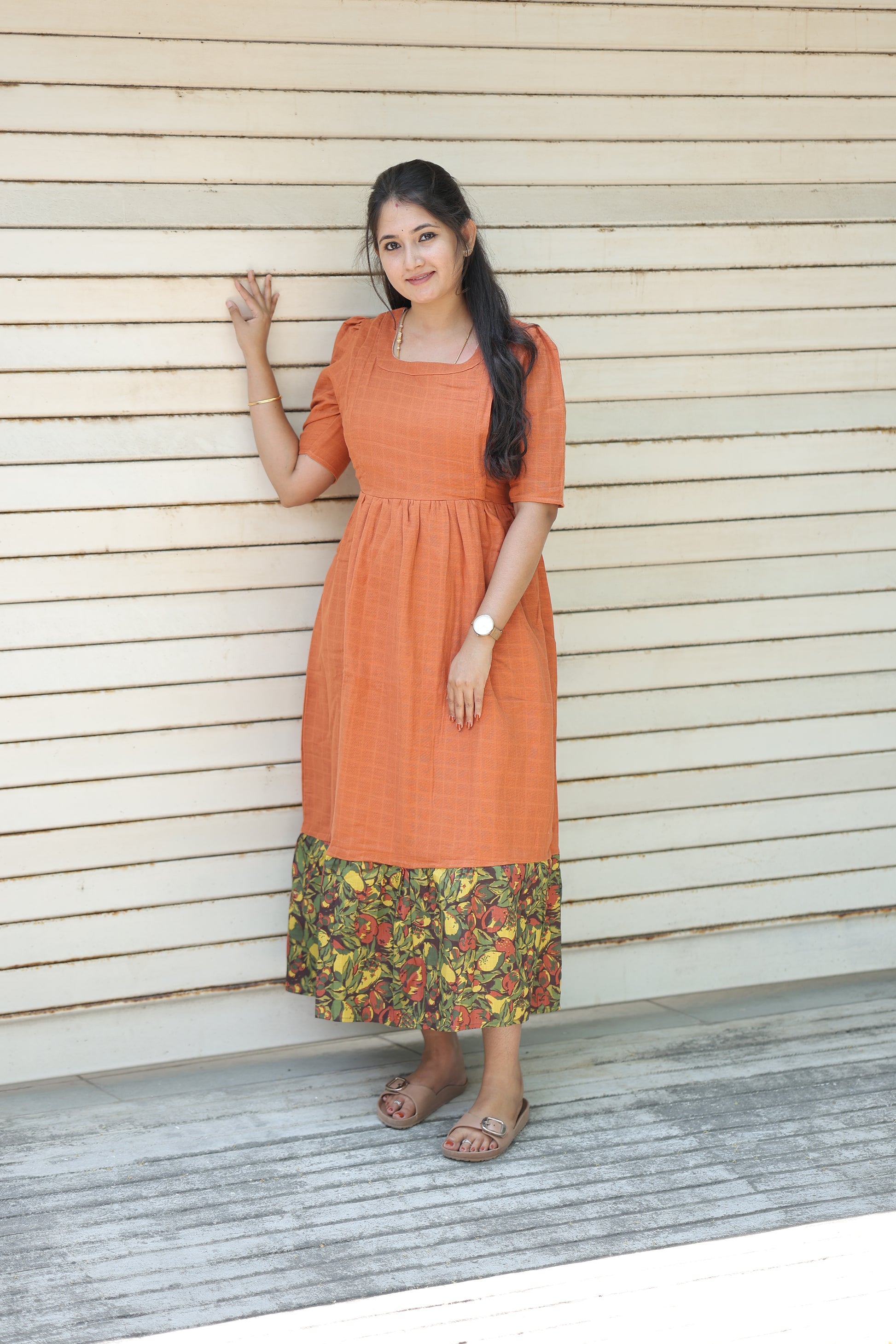 Neemai Peach muslin cotton feeding dress with floral printed hem, breathable summer friendly fabric, lightweight maternity wear with relaxed fit and elegant flowy design.