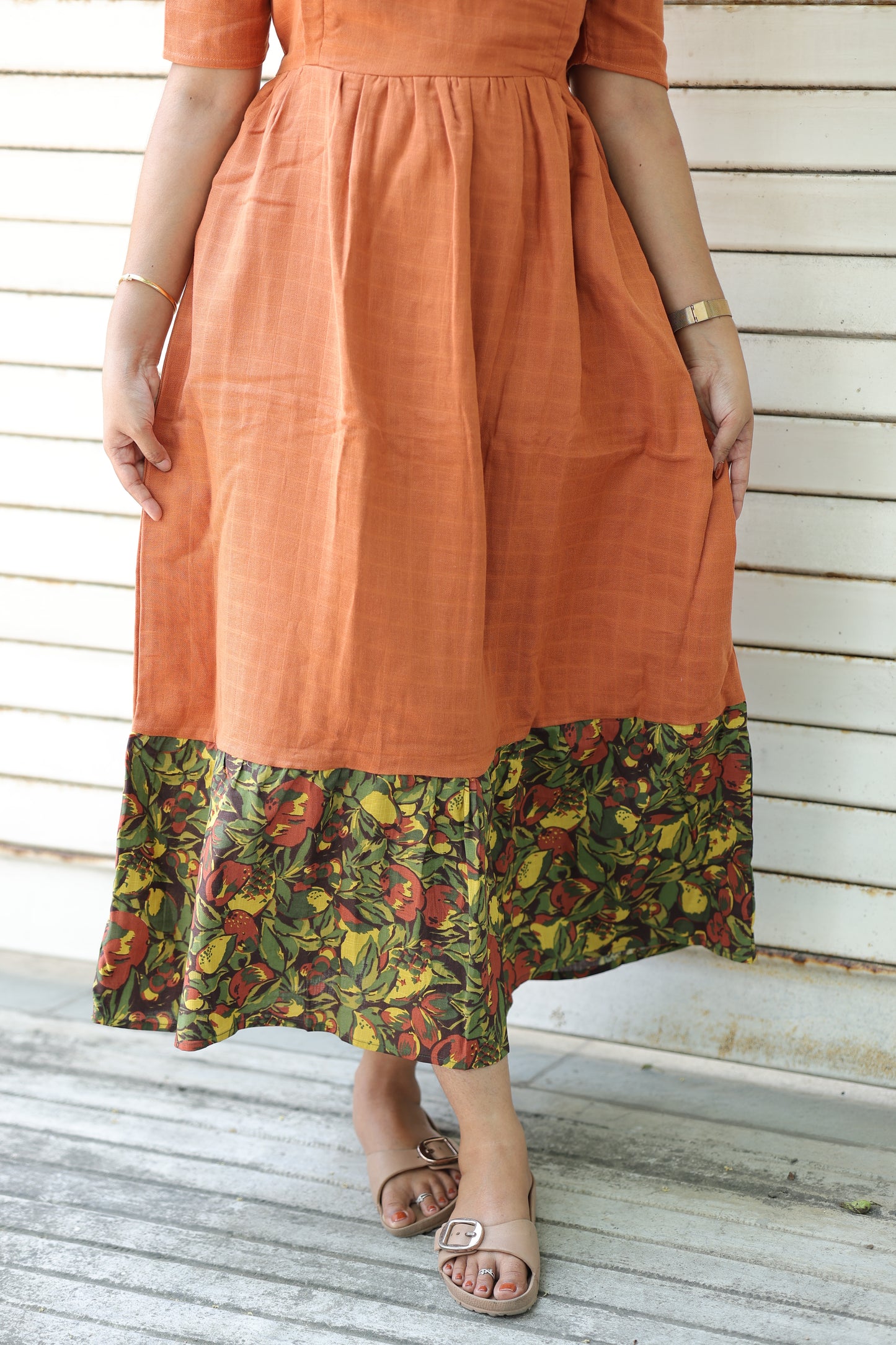 Peach muslin feeding gown with floral border detailing, soft skin friendly fabric, flowy summer maxi dress perfect for hot weather comfort and casual wear.