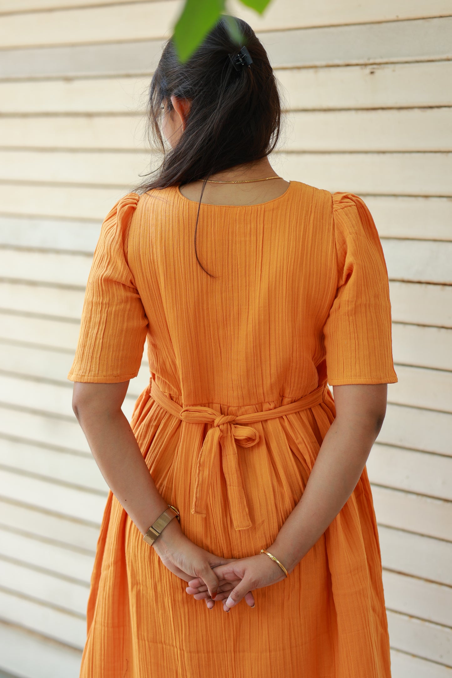 Back view of orange muslin maternity and feeding gown with adjustable waist tie, relaxed comfortable fit for pregnancy moms, plus size maternity clothing 