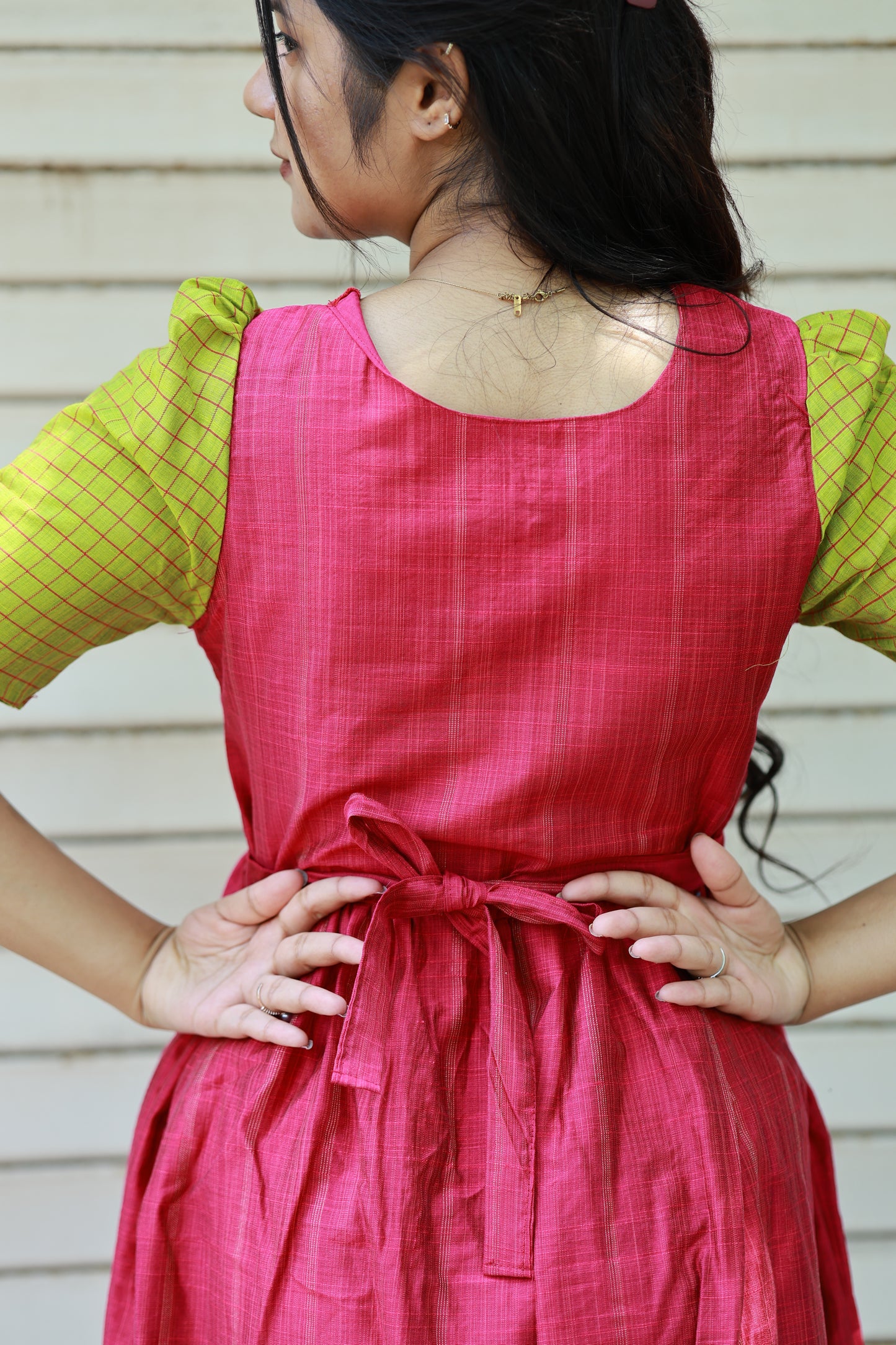 Neemai pink butter silk maternity gown with back tie knot detail, green checked puff sleeves, stylish everyday wear