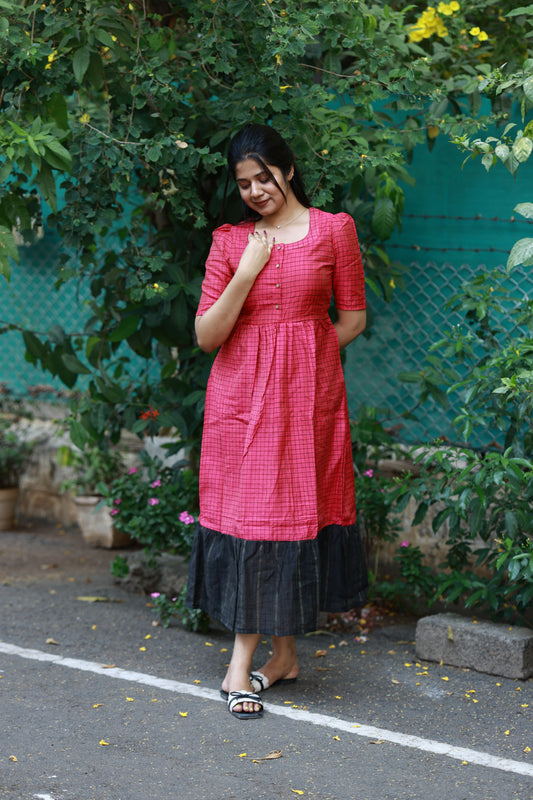 Neemai pink butter silk maternity maxi dress with black contrast hem and check pattern, flowy silhouette, summer friendly festive and casual wear