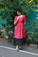 Neemai pink butter silk maternity maxi dress with black contrast hem and check pattern, flowy silhouette, summer friendly festive and casual wear