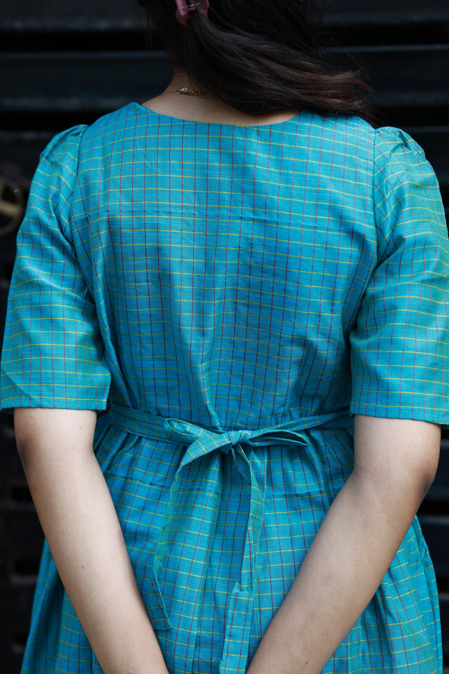Neemai back view teal butter silk checkered maternity dress with tie-up detail, bump friendly ethnic wear, comfortable office wear for pregnancy moms