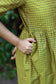 Neemai green butter silk gown with functional pocket details, pregnancy and postpartum friendly maxi gown