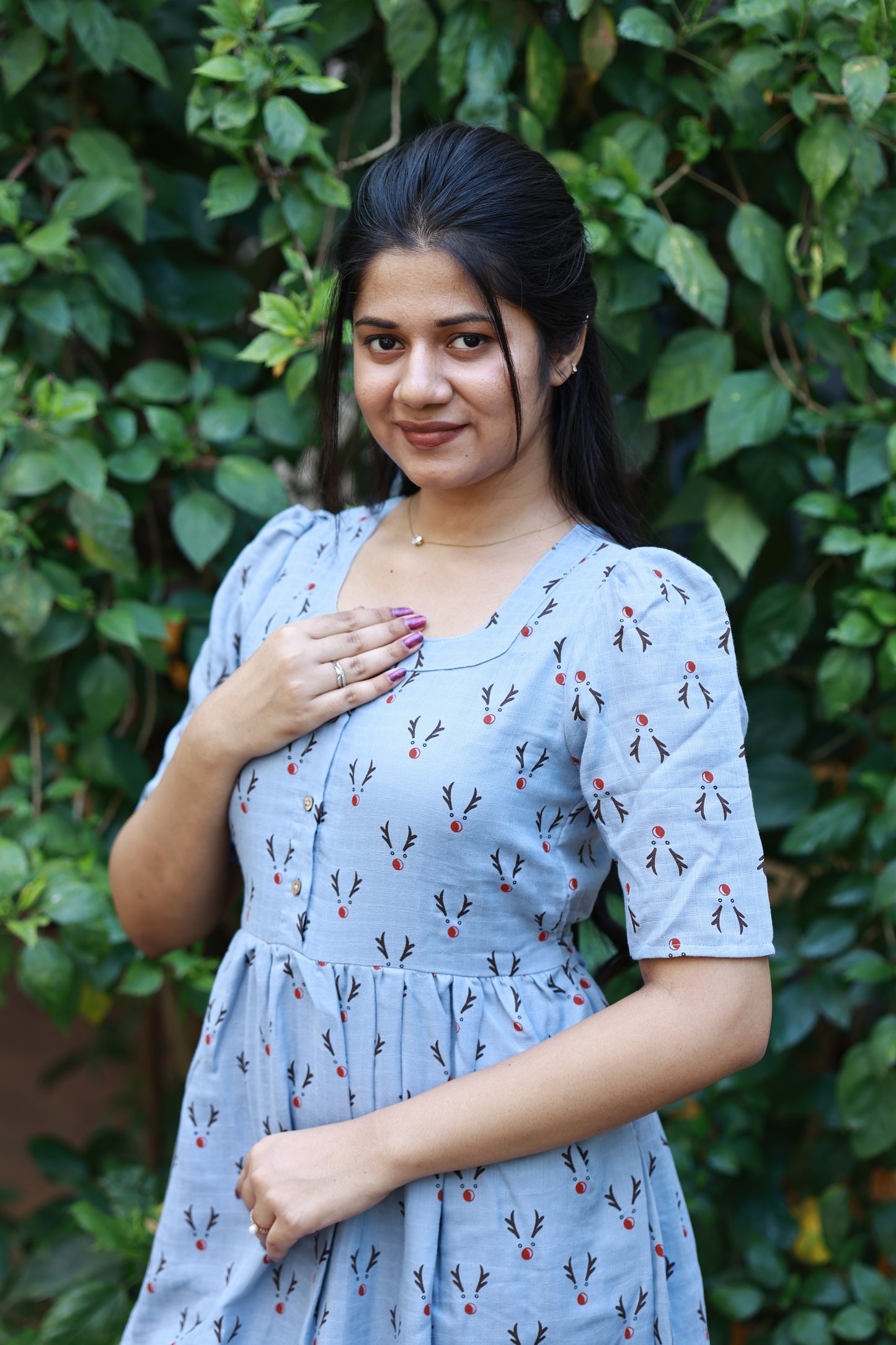 Stylish light blue feeding maxi dress with delicate printed pattern, puff sleeves and comfortable maternity friendly silhouette for casual outings.