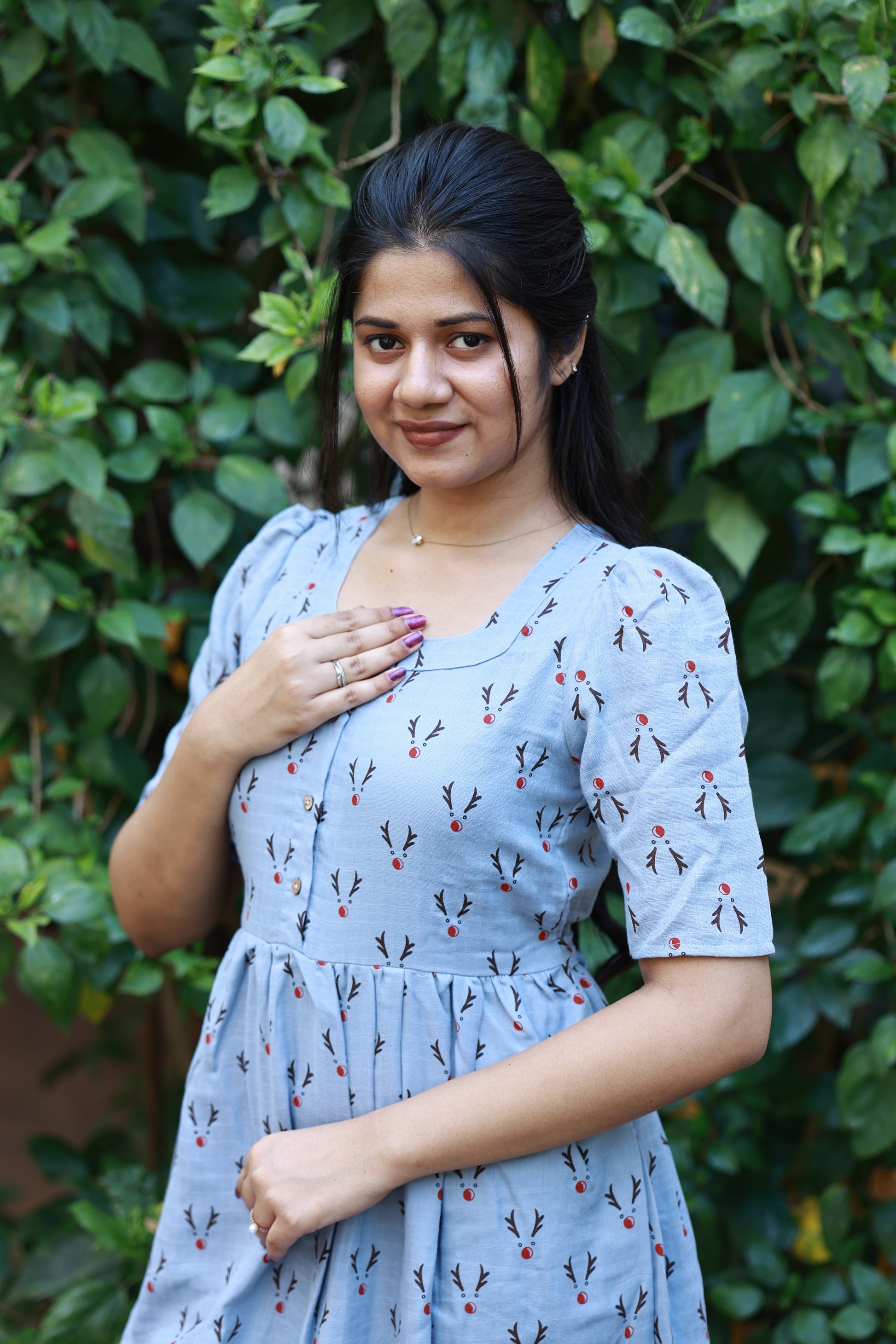 Stylish light blue feeding maxi dress with delicate printed pattern, puff sleeves and comfortable maternity friendly silhouette for casual outings.