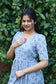 Stylish light blue feeding maxi dress with delicate printed pattern, puff sleeves and comfortable maternity friendly silhouette for casual outings.