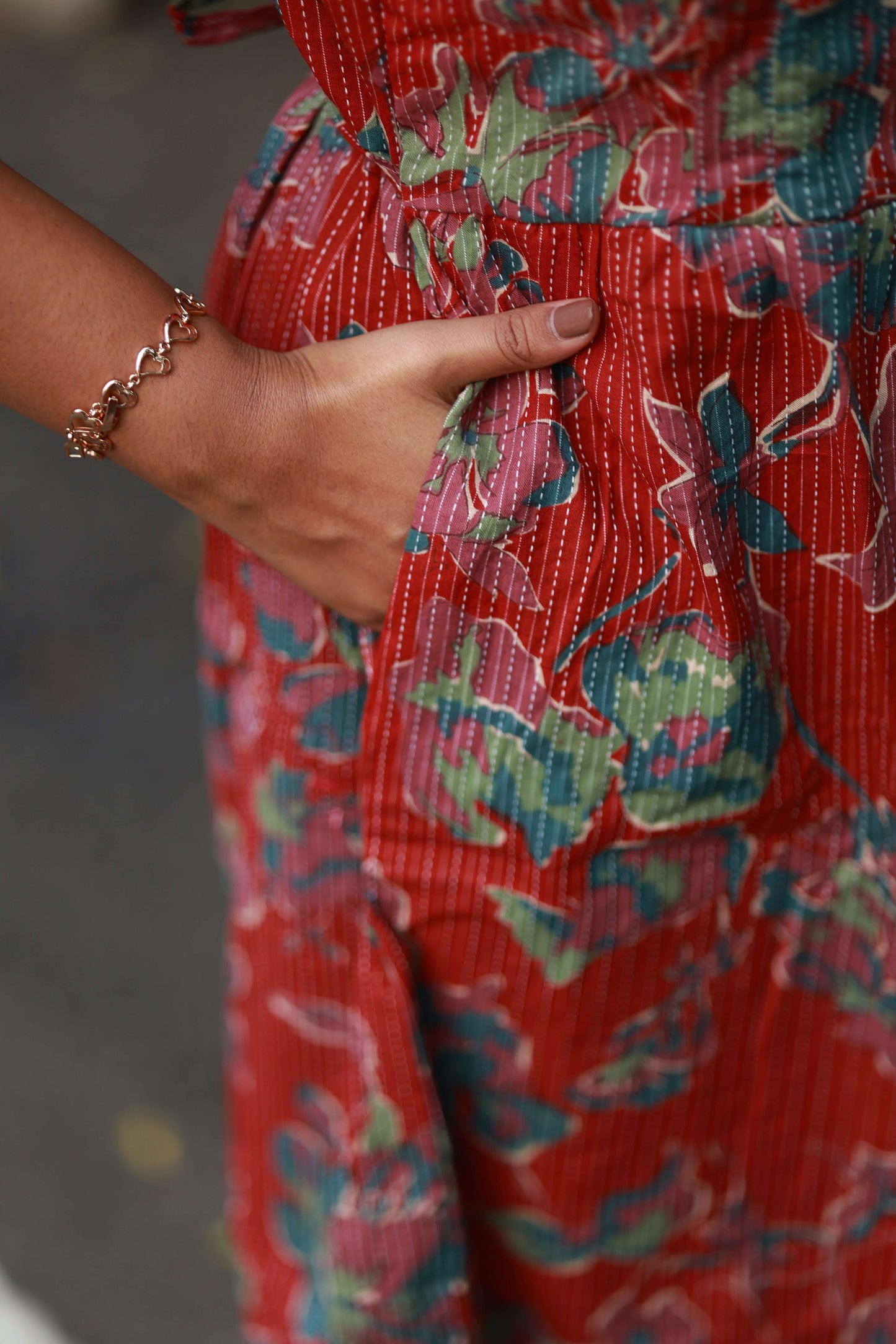 Maternity Midi/Gown - Wildflower Rust showing floral design, side pocket, and model's hand on the waist.