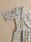 Neemai white cotton feeding gown with playful cloud print, front zipper nursing access and plu size summer friendly maternity wear styling.